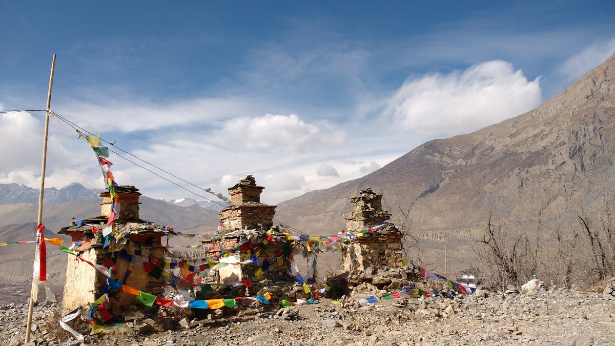 Stone chortens draped in prayer flags (historical photograph)