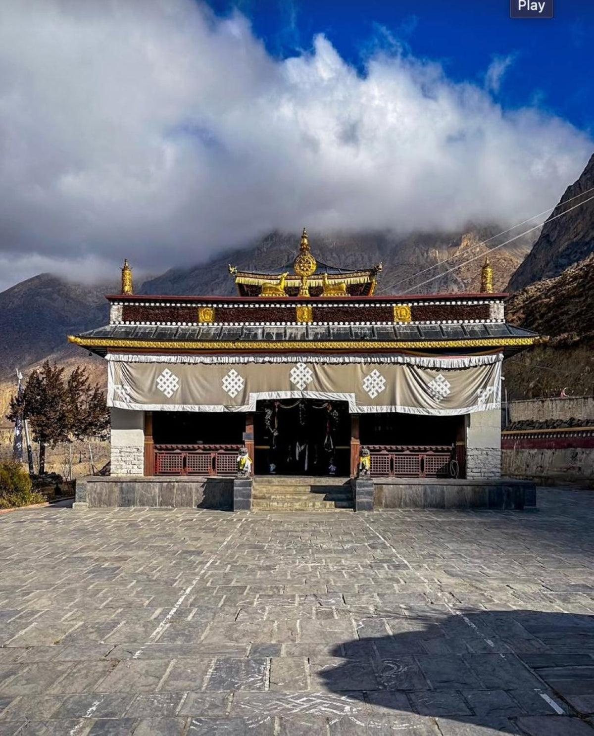 Tibetan Buddhist temple facade with gilded roof ornaments