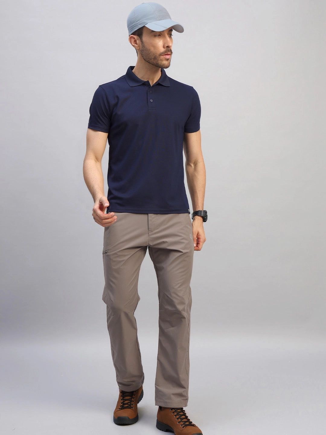 Man wearing the Reccy Men's Navy Blue Polo T-Shirt with a cap, full length view