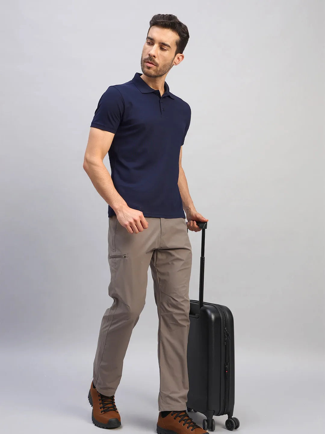 Man wearing the Reccy Men's Navy Blue Polo T-Shirt with luggage, full length view
